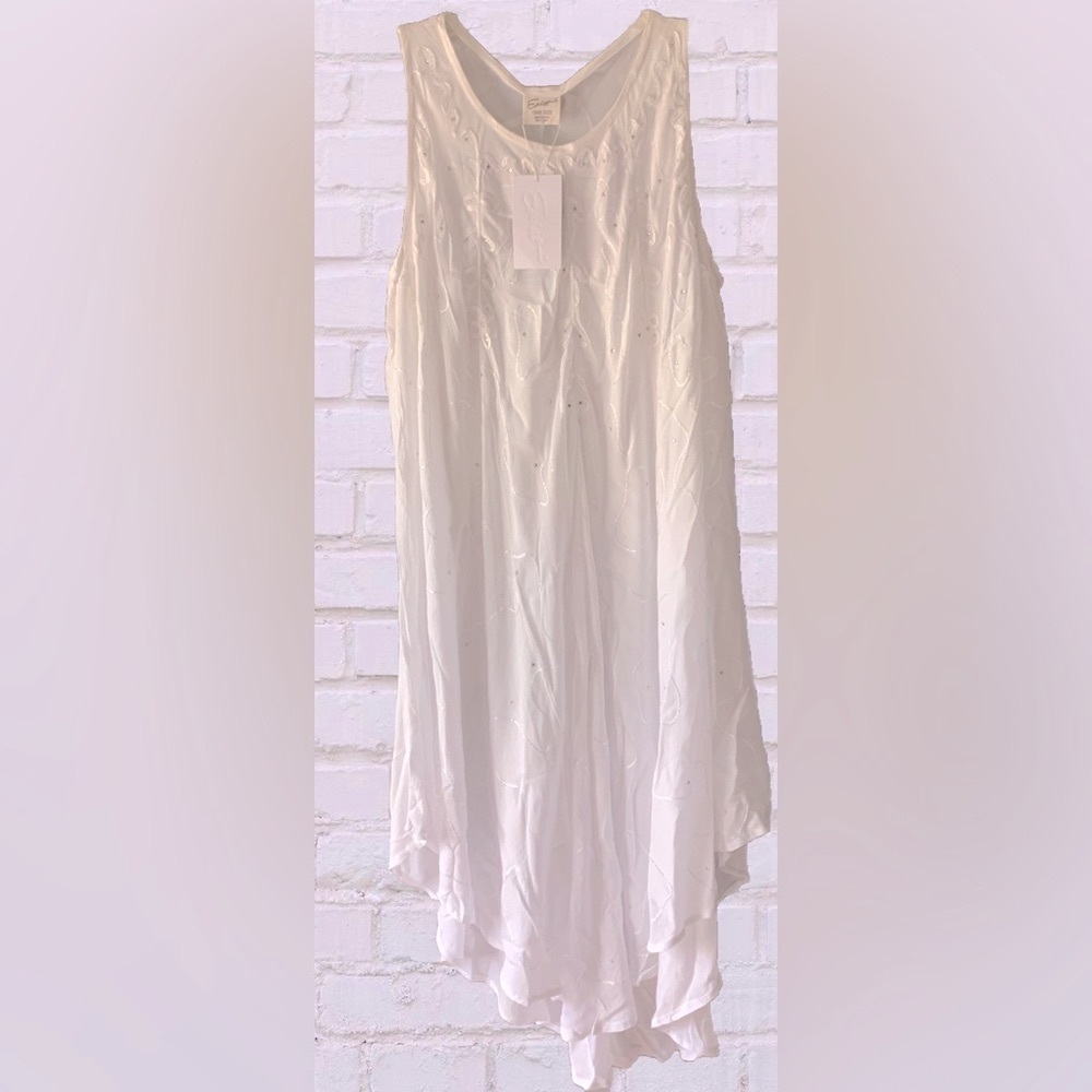 WHITE ASYMMETRICAL NWT measures:Bust-32in. Shoulder to hem 50 in. Armhole- 11in.